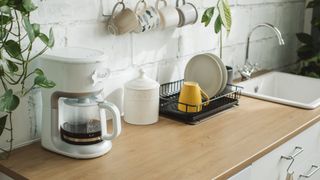 picture of coffee perculator on counter top near sink