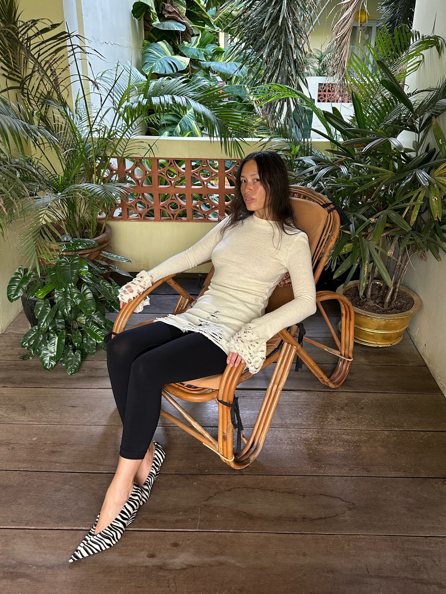 Anne-Victorie wears a cream top with leggings and animal print heels