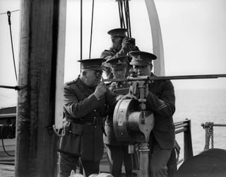 Ship's captain looks through telescope