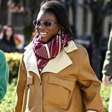 nikki ogunnaike wearing a brown coat