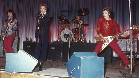  Glen Matlock, Johnny Rotten, Paul Cook, and Steve Jones performing live onstage at Dunstable's Queensway Hall.