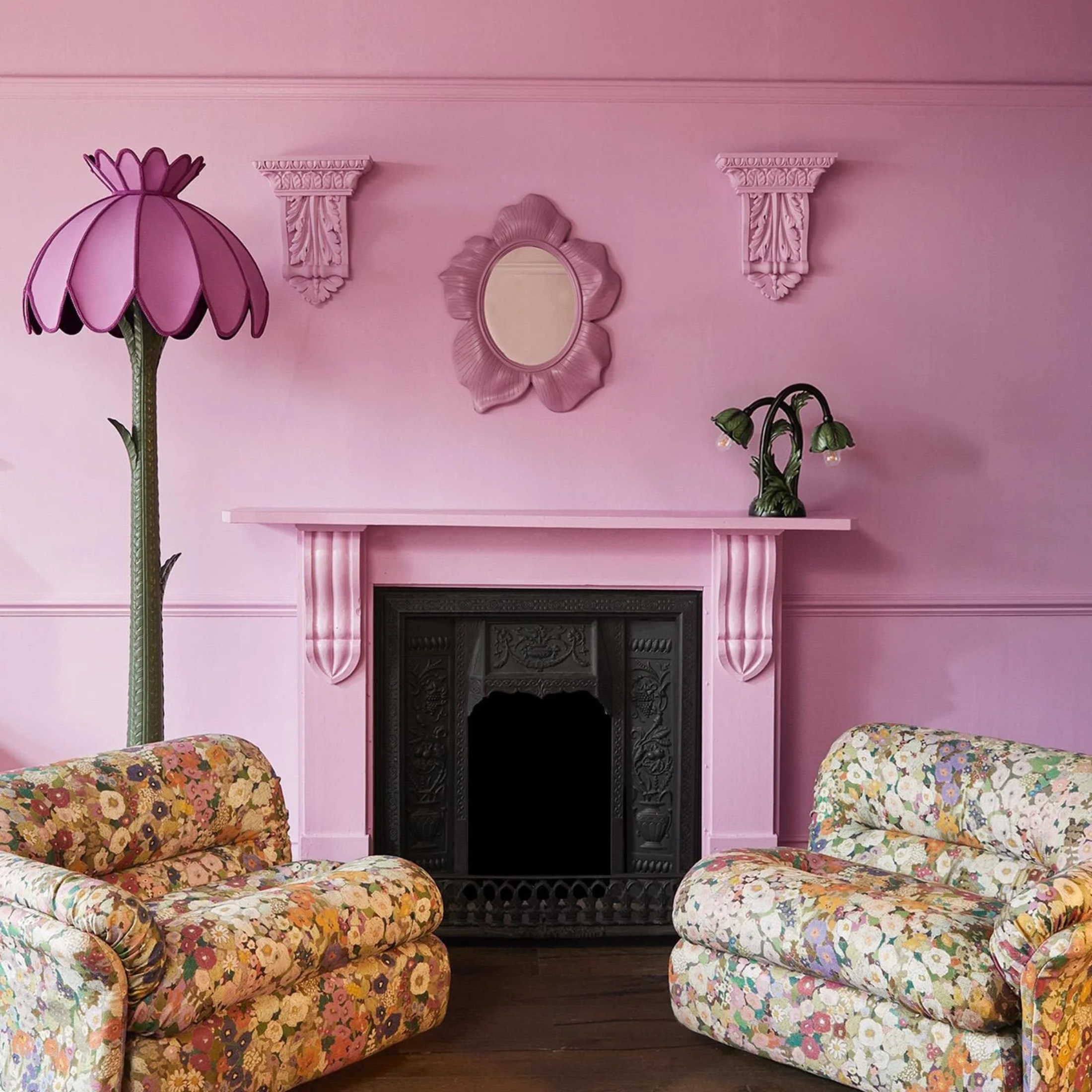 a pink living room with floral sofas