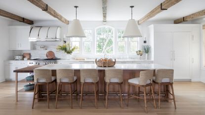 hamptons style white kitchen with jute island stools