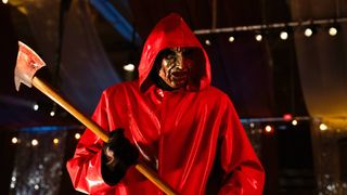 A masked figure with an axe in Netflix's "Fear Street: Prom Queen"