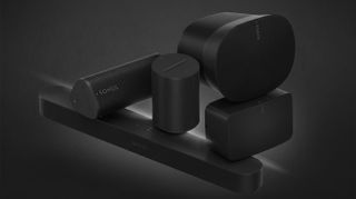 A collage of Sonos speakers and soundbars stacked on top of each other on a smoky black background