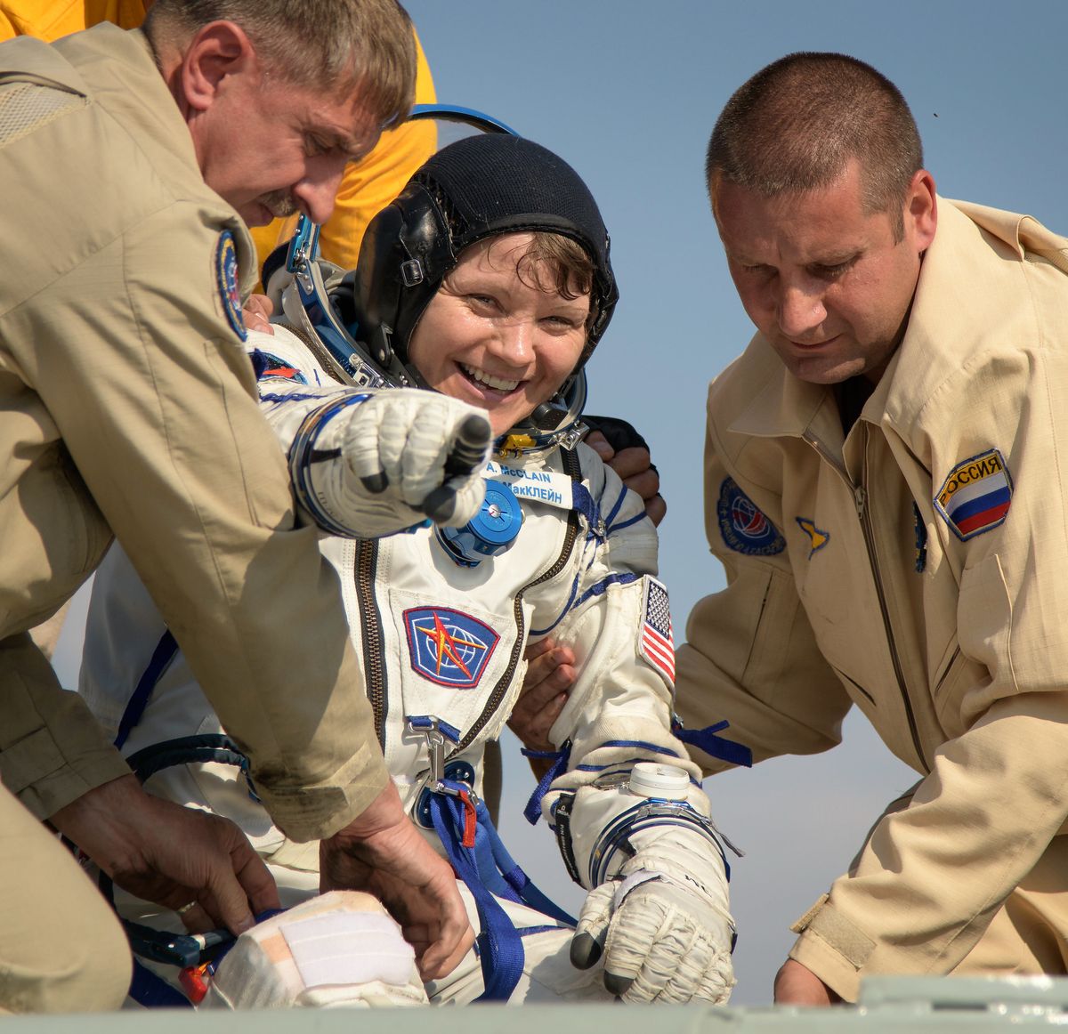 NASA astronaut Anne McClain is assisted out of the Soyuz MS-11 that returned her and crewmates Oleg Kononenko of the Russian space agency Roscosmos and David Saint-Jacques of the Canadian Space Agency back to Earth on June 24, 2019.