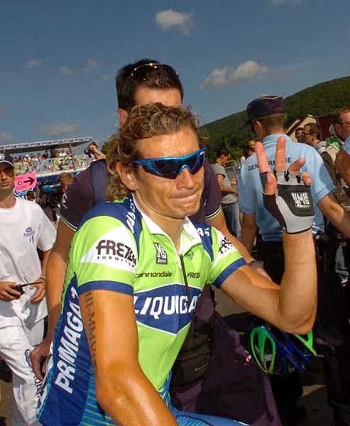 The stage winner, Pozatto gives a wave after taking stage five