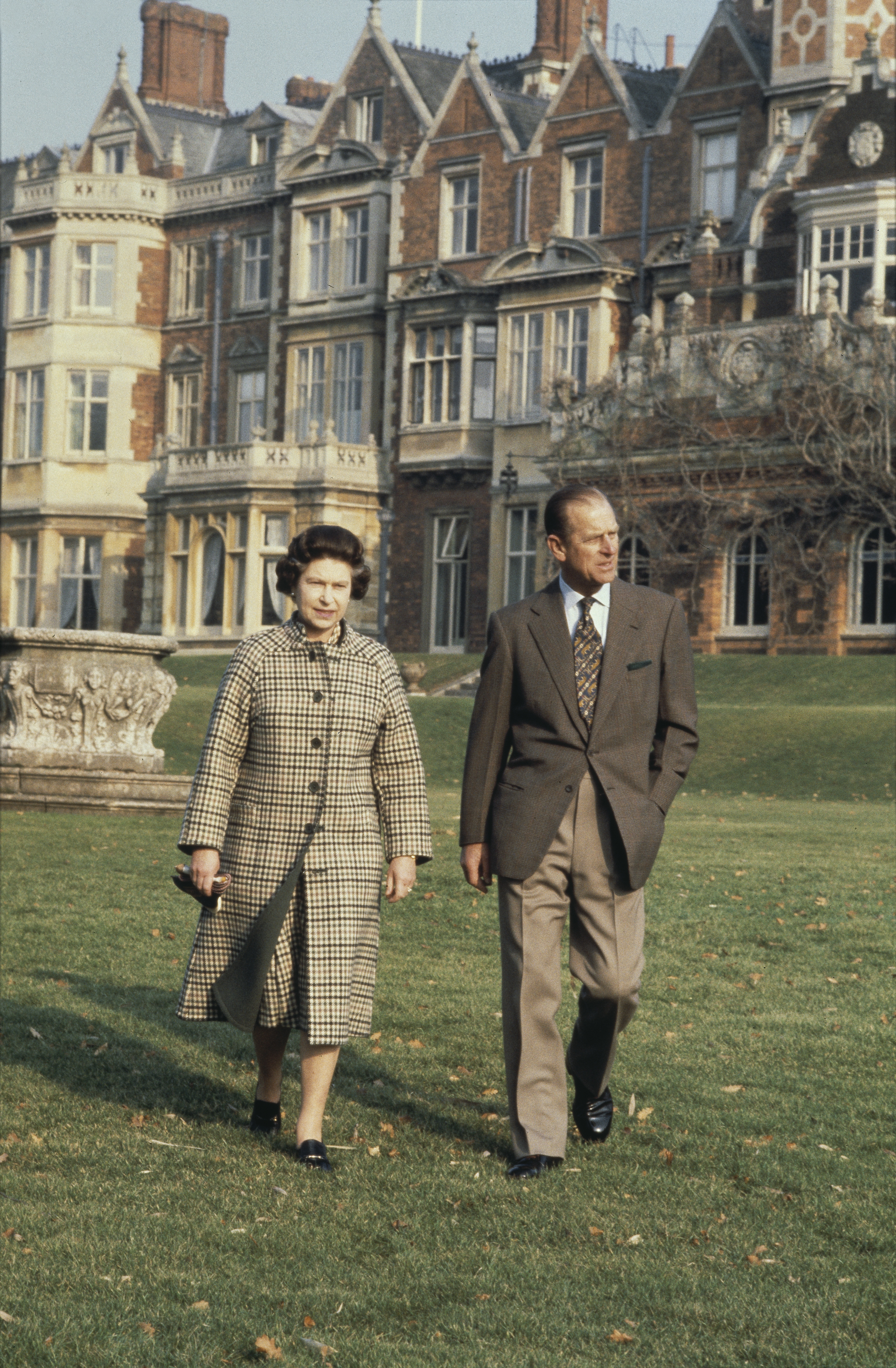 Queen Elizabeth walking with Prince Philip outside Sandringham House