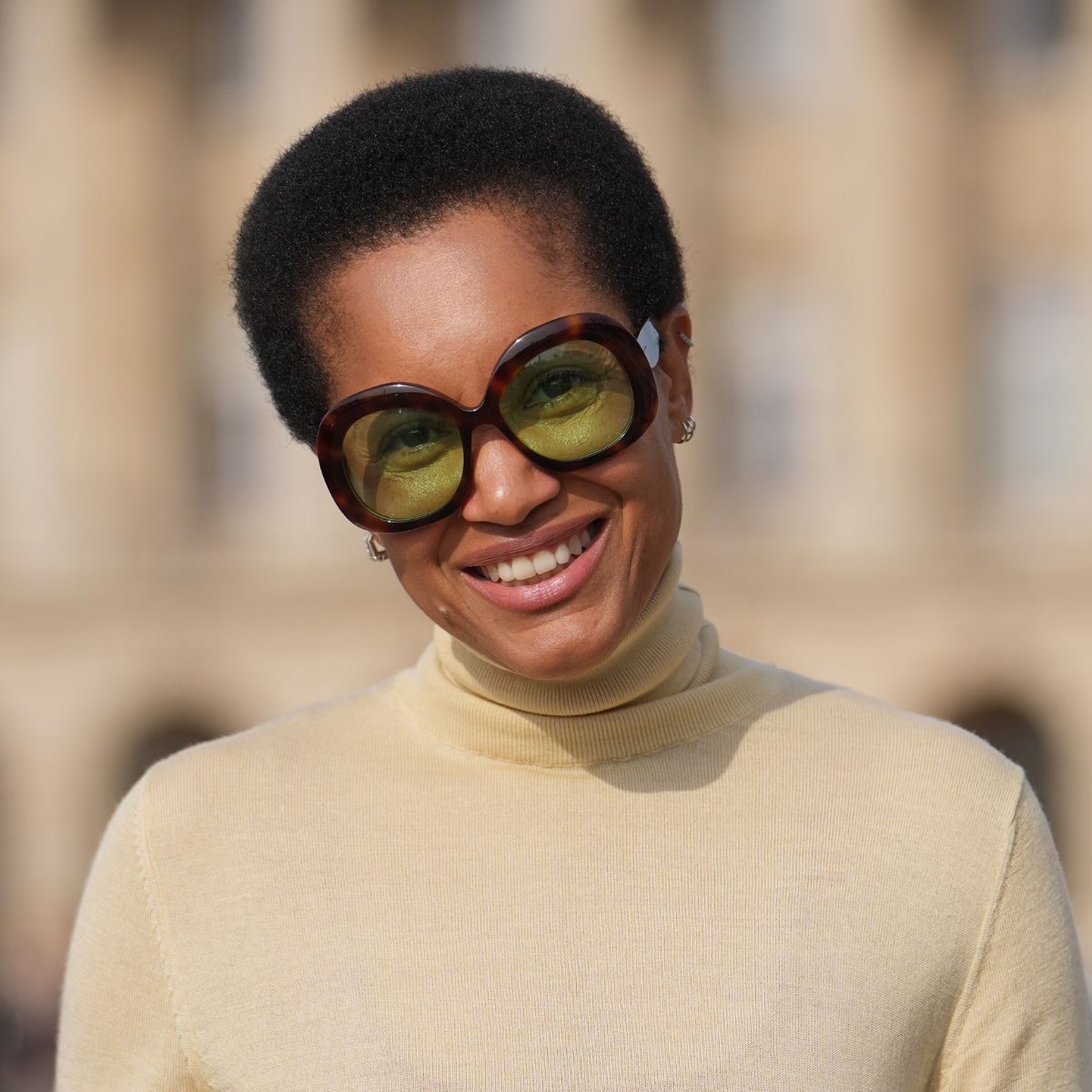 woman with cropped afro hair wearing oversized sunglasses