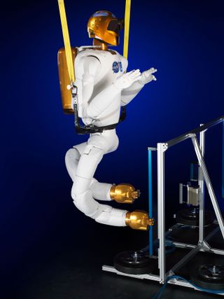 This image shows NASA’s Robonaut 2 with newly developed climbing legs, designed to give the robot mobility in zero gravity. With legs, Robonaut 2 will be able to assist astronauts with both hands while keeping at least one leg anchored to the station structure at all times. Image released Nov. 13, 2013.