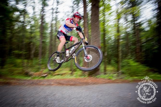 Kurt Gensheimer hits the road gap on his singlespeed on the enduro segment