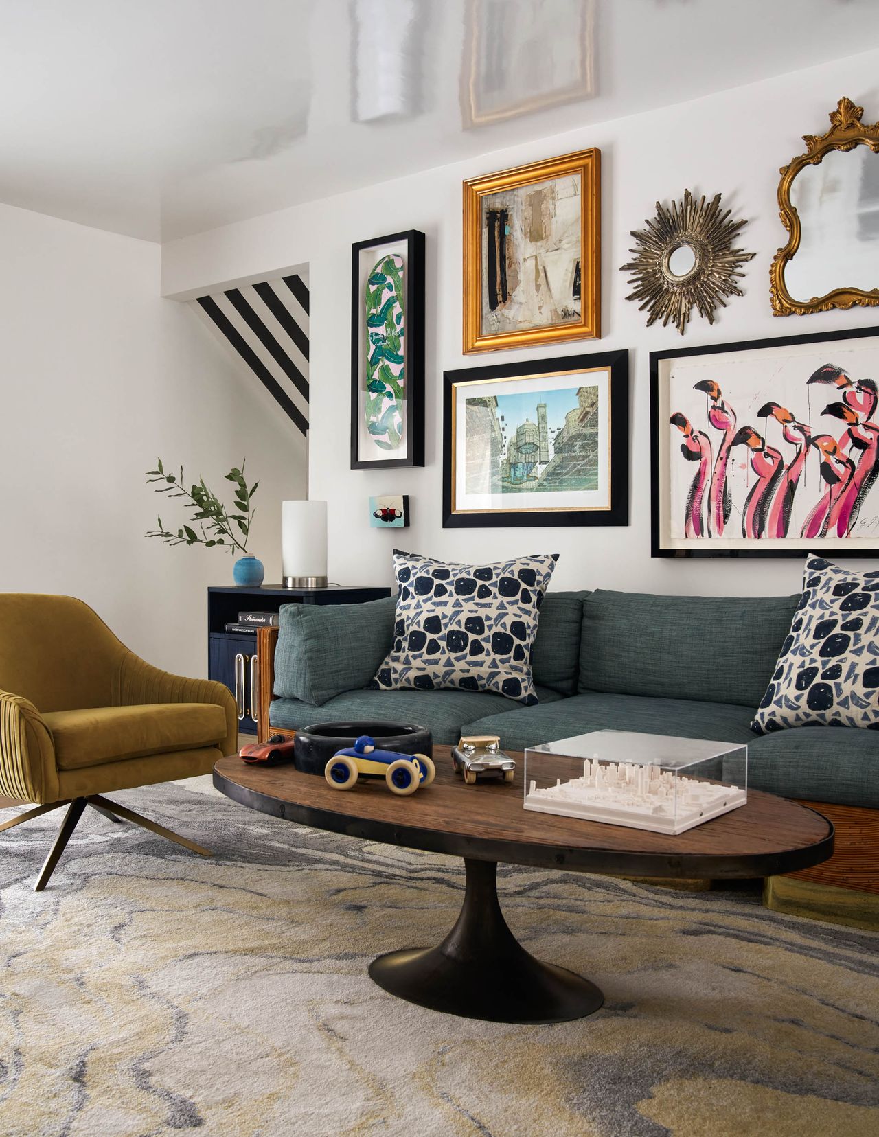 white living room with retro furniture, blue sofa, gallery wall and lacquered ceiling 