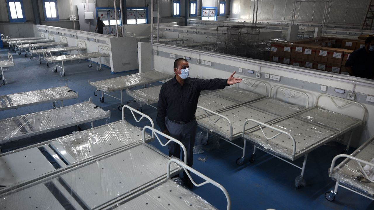 Beds being fitted in a temporary Covid-19 care centre in Mumbai, India