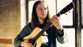 Billy Strings poses with his Martin DX-2E Billy Strings acoustic-electric guitar