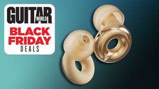 A pair of gold Loop earplugs against a dark blue background