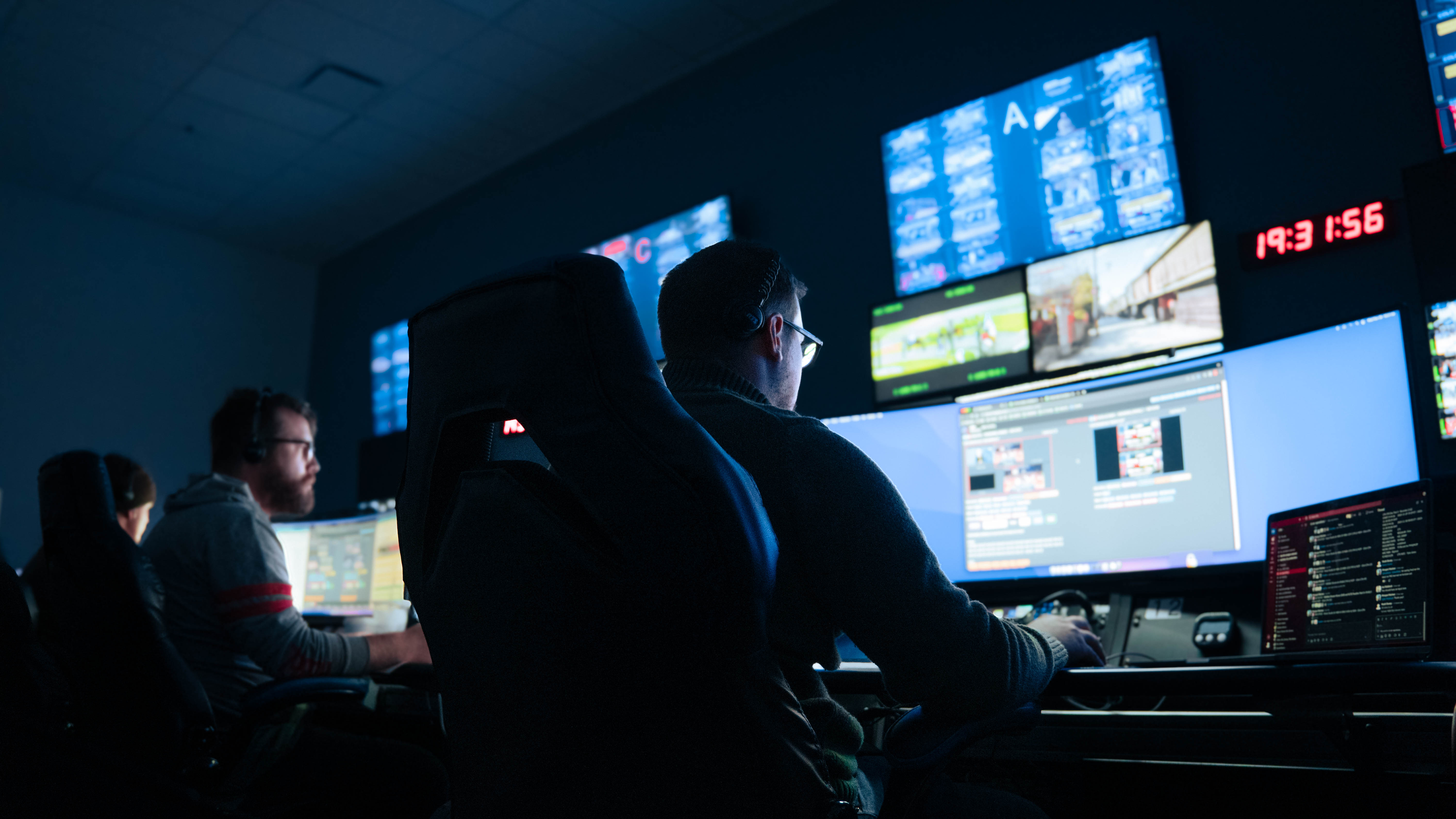 Men working in a dark control room