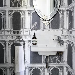 wallpaper on wall with mirror and towel hanger