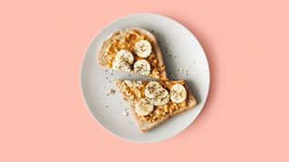 Slice of toast cut in half with banana and peanut butter