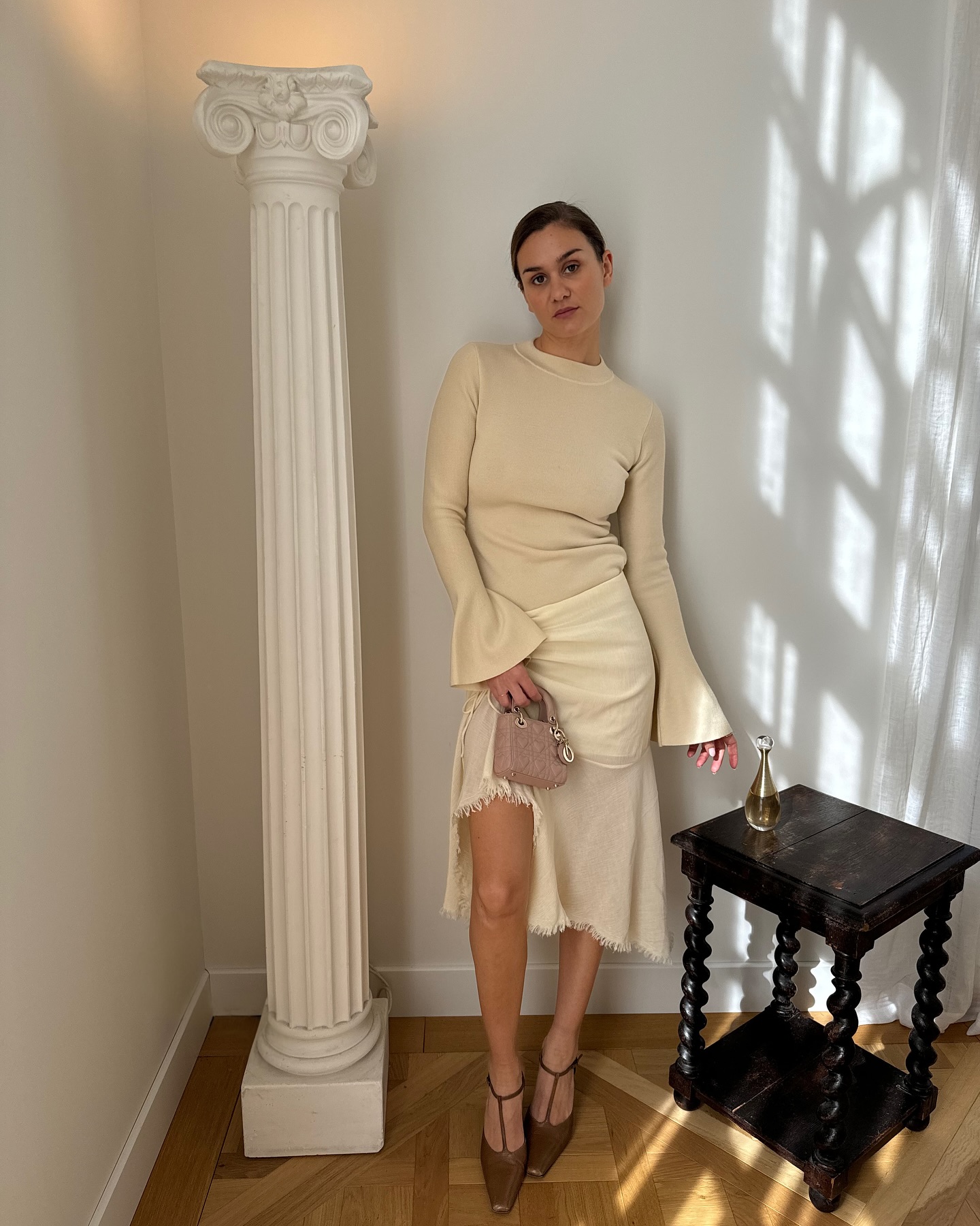 Woman in pale yellow top and skirt