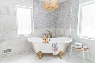 clawfoot bath in marble bathroom