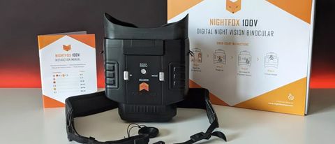 The Nighfox 100V with it's packaging and instruction manual on a black backdrop