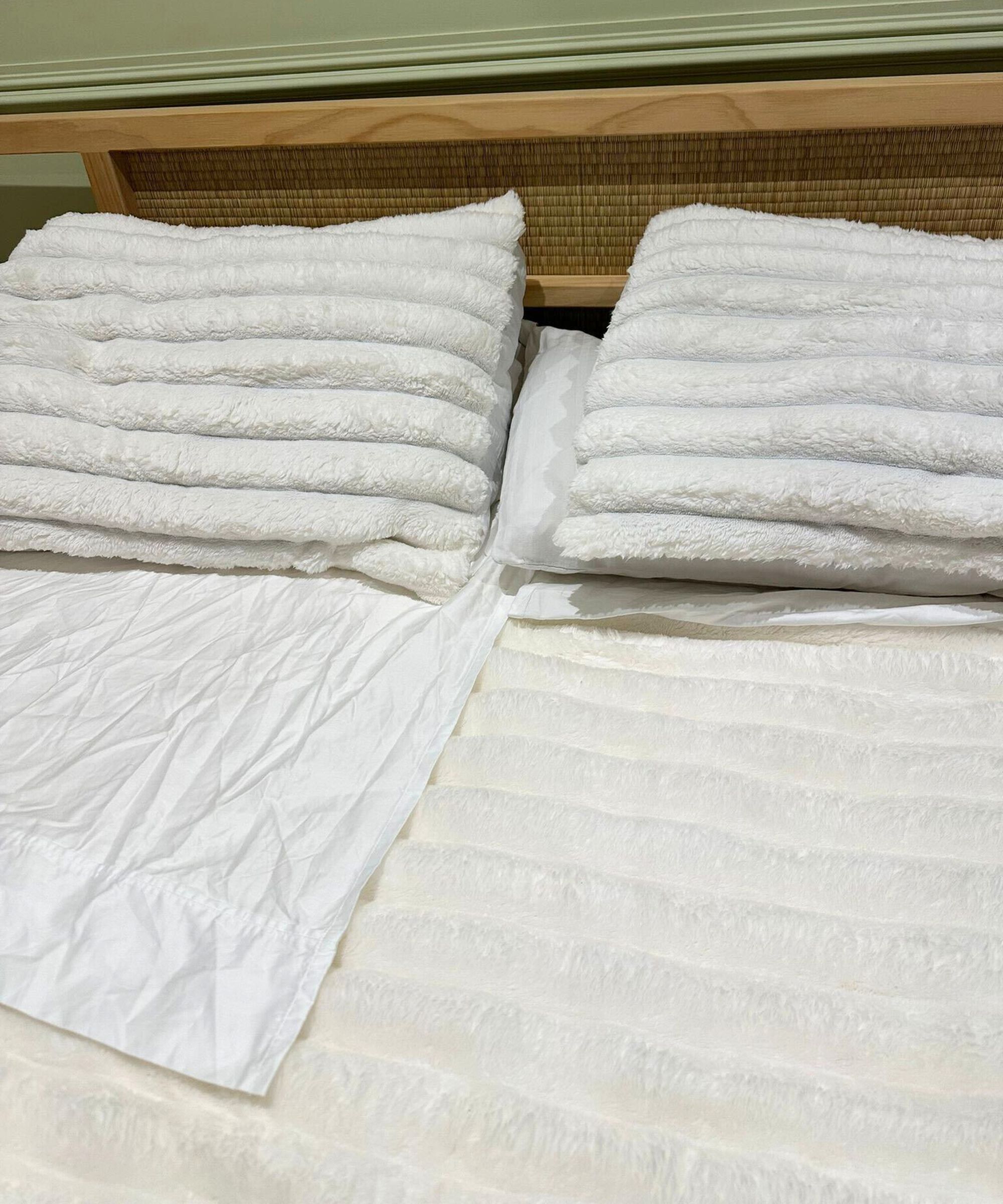 Dreamwings white bed sheets on my Japan-style bed with a fluffy white comforter and pillow set.