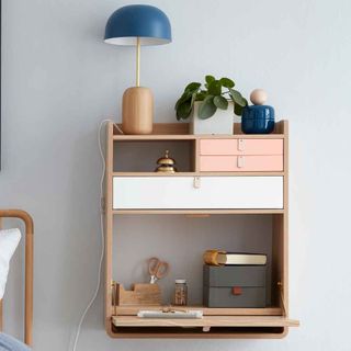 white wall with wooden shelve lamp