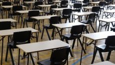 A room full of empty desks and chairs prepared for an exam