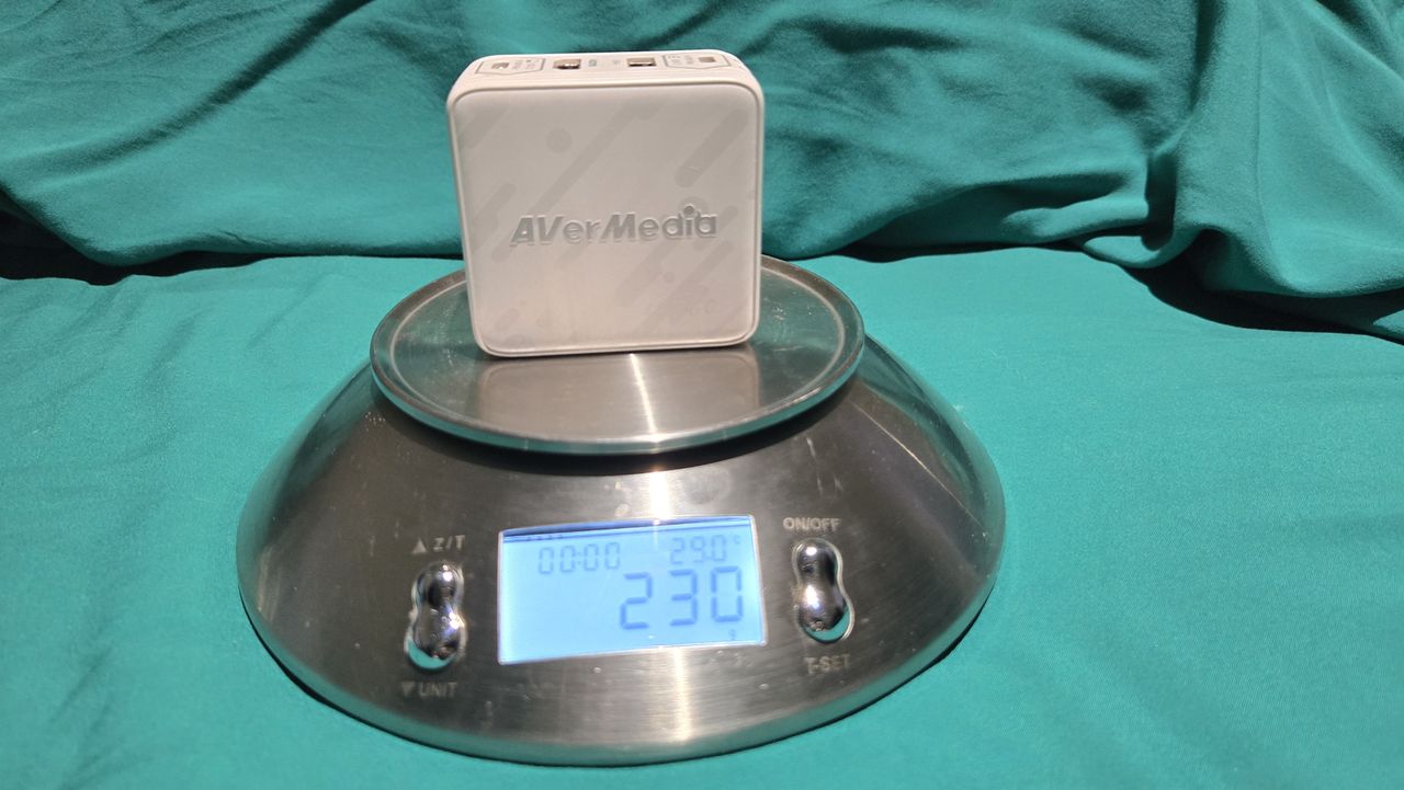 AVerMedia Elite Go GC313Pro on a turquoise sheet with cables.