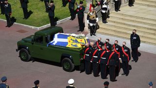 Pallbearers of the Royal Marines stand by the coffin as it arrives at the West Steps of St George's Chapel during the ceremonial funeral procession of Britain's Prince Philip, Duke of Edinburgh in Windsor Castle in Windsor