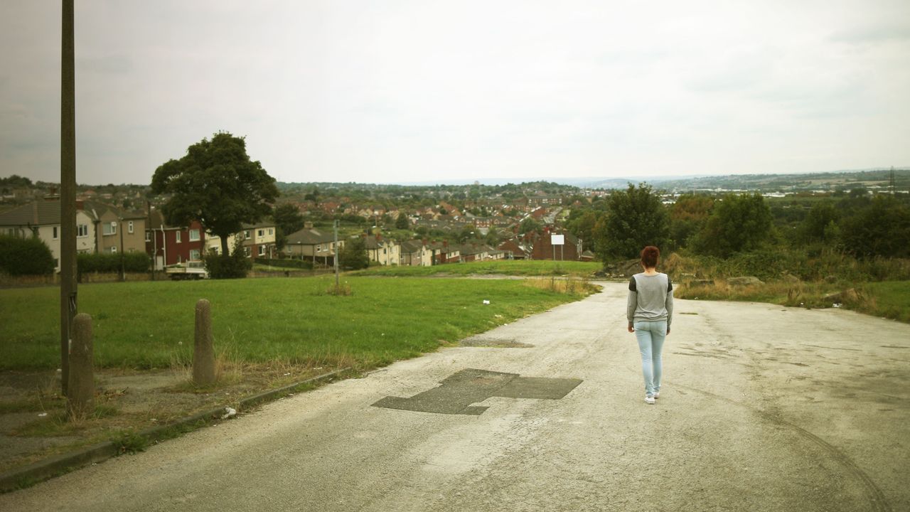 A woman walks down a road