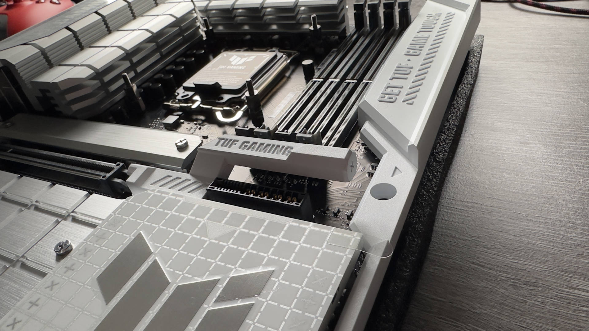 Asus TUF Gaming Z790-BTF motherboard on a grey desk