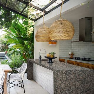 Outdoor kitchen with island and two pendant lights