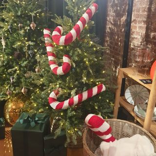 A Next Christmas tree decorated with oversized candy cane decorations