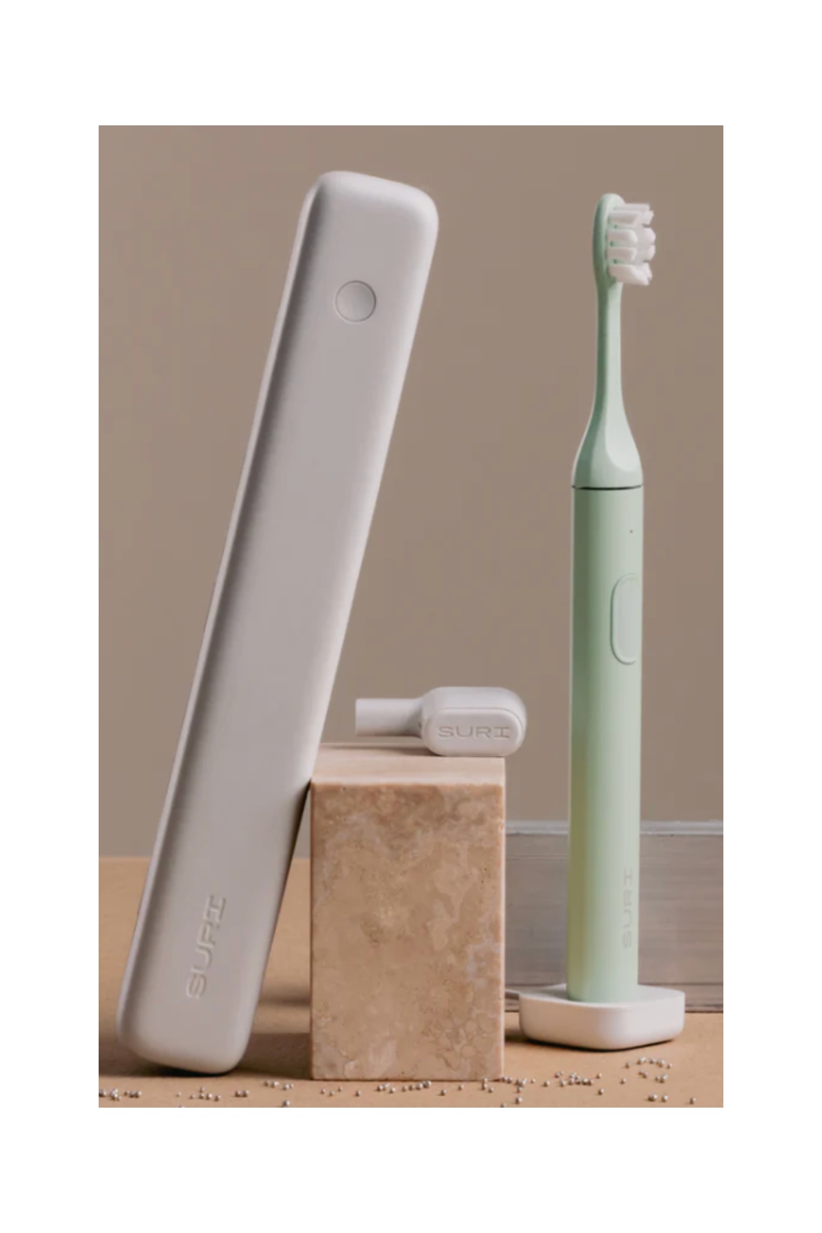 a mint electric toothbrush next to a gray traveling case