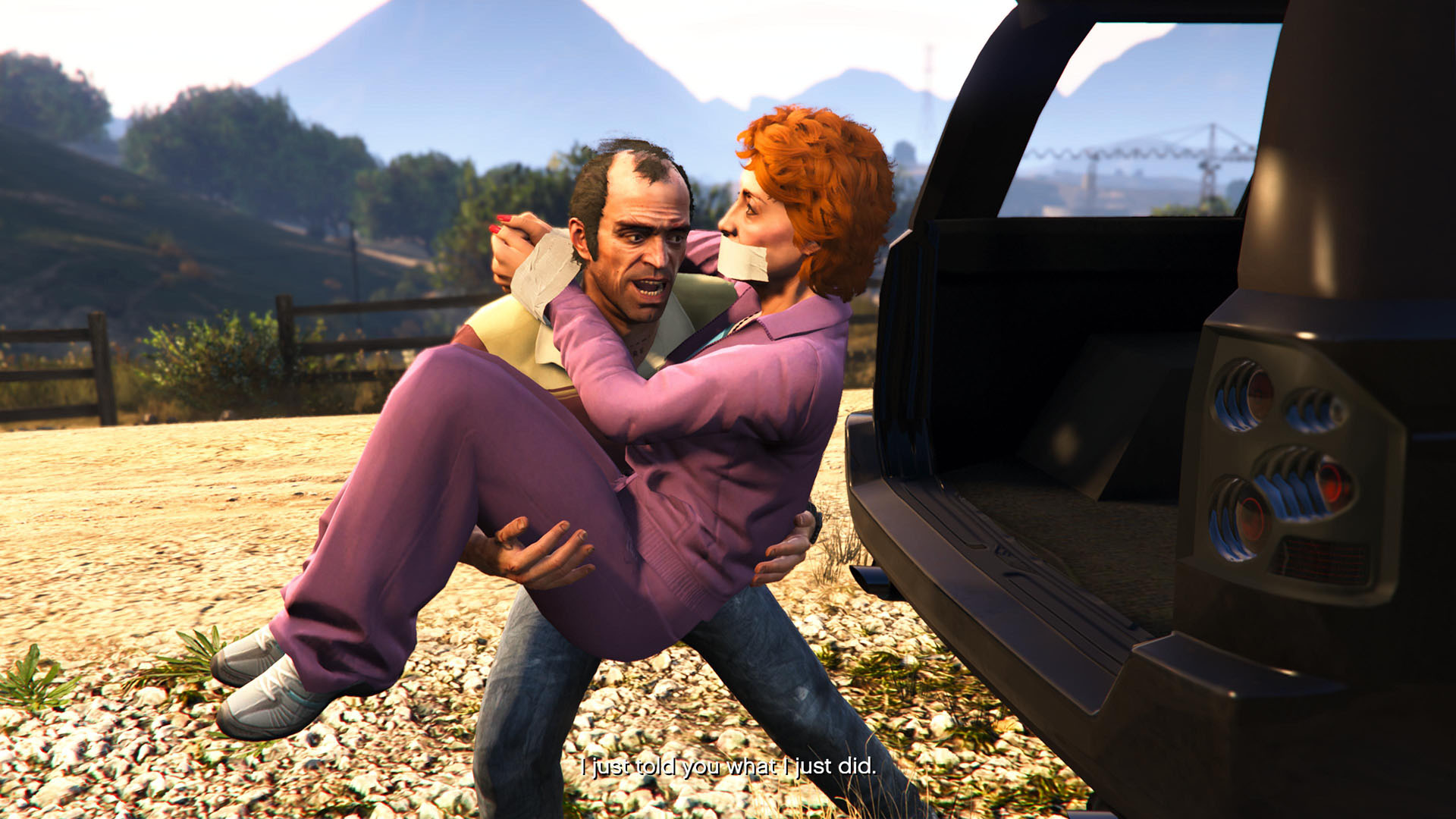 Trevor carries a bound Patricia into a car in Grand Theft Auto 5