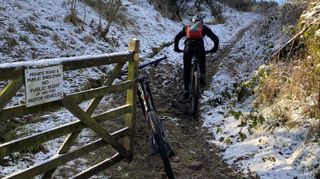 Riding through a gate on a snowy trail