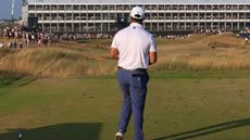 Jon Rahm throws a club