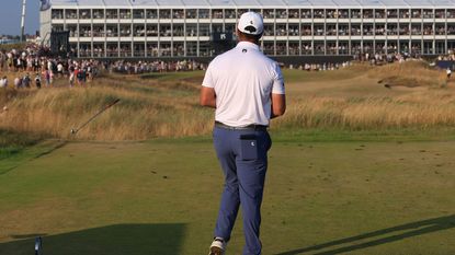Jon Rahm throws a club