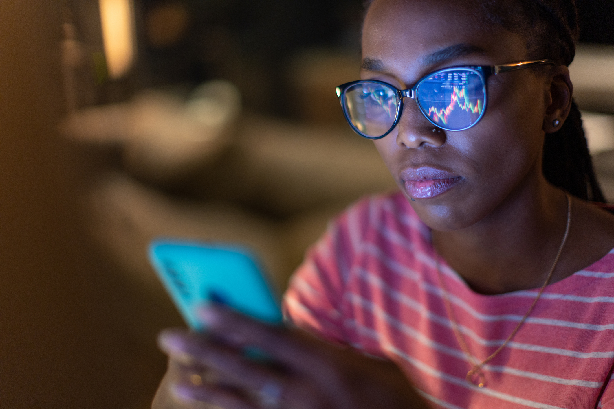 Woman looking at financial markets on phone