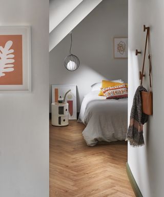 loft bedroom with wooden herringbone flooring