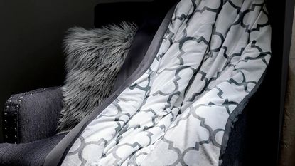 Luxome Weighted Blanket draped over an armchair.