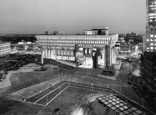 Black and white image of Boston City Hall with Lights on at night