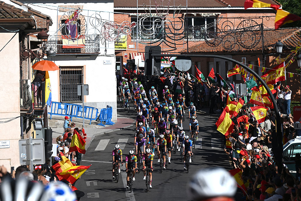 ALAPARDO, SPAIN - SEPTEMBER 14: A general view of the peloton passing through a village while fans cheers during the La Vuelta - 80th Tour of Spain 2025, Stage 21 a 108km stage from Alalpardo to Madrid / #UCIWT / on September 14, 2025 in Alalpardo, Spain. (Photo by Dario Belingheri/Getty Images)