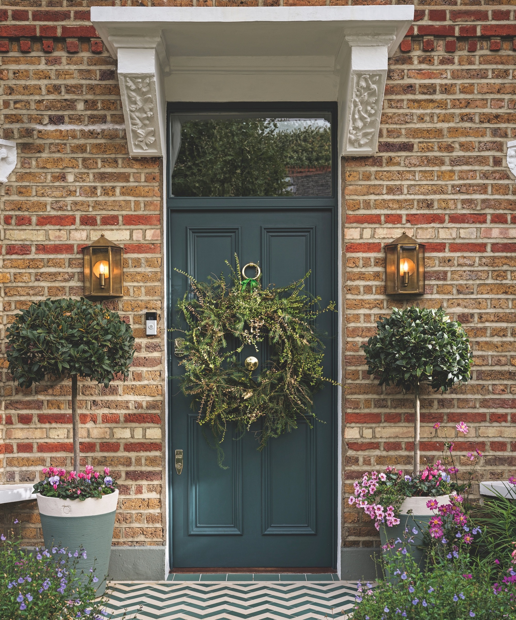 Dark green front door with huge Christmas wreath