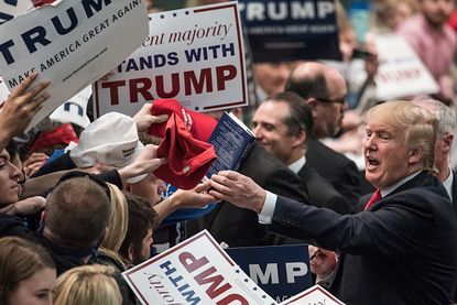 Donald Trump greets supporters at a rally.