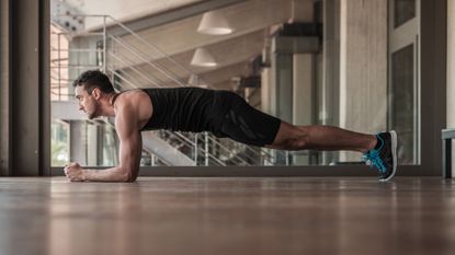 Man doing a plank, one of the best workouts for abs