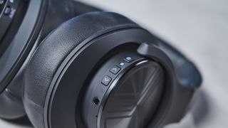 A black Treblab Z2 over-hear headset with a gray logo on each earcup