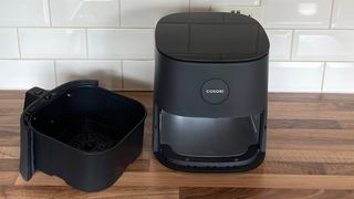 The Cosori Pro LE Air Fryer L501 on a kitchen countertop with the basket removed