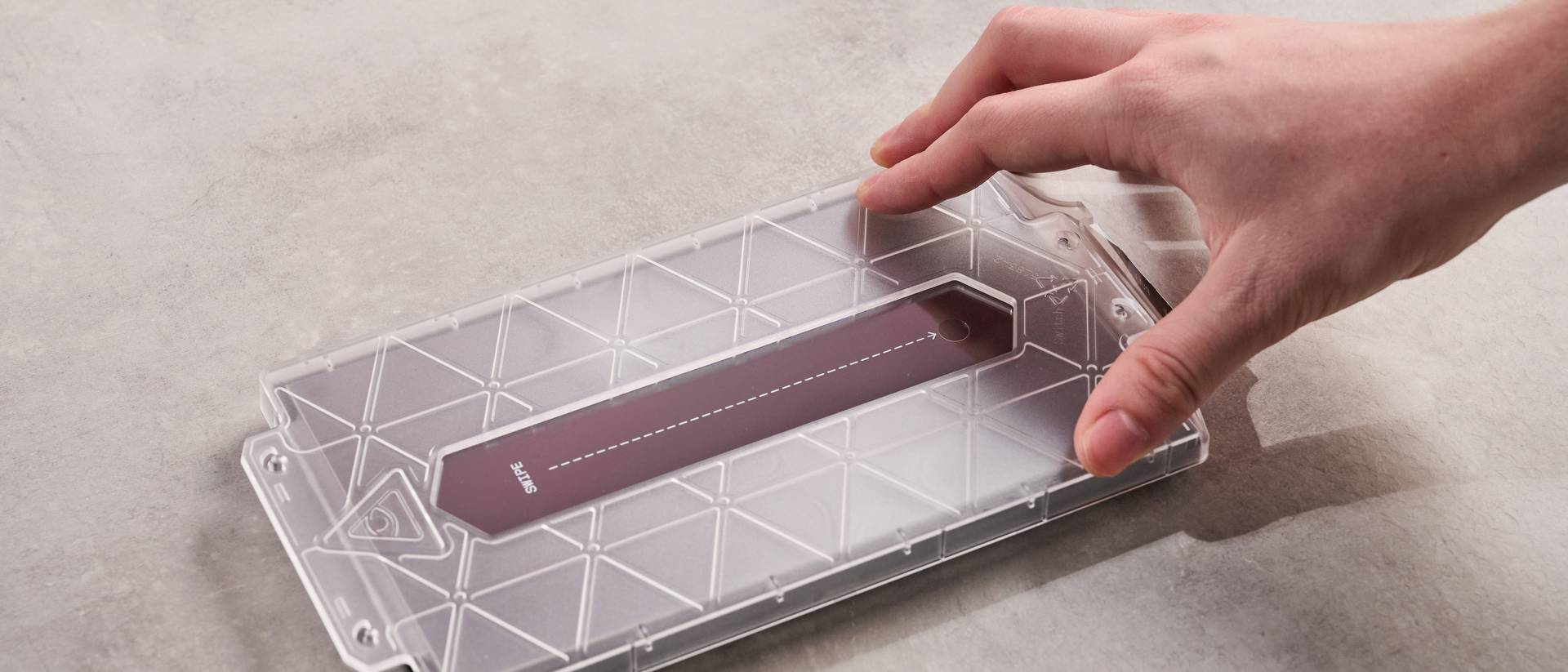 Person placing application frame onto the DBrand Prism 2.0 for Nintendo Switch 2